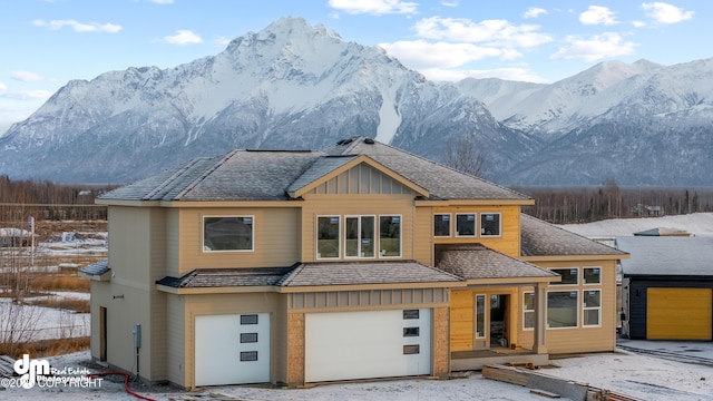 view of front of home with a garage and a mountain view