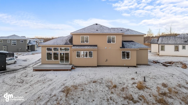 rear view of house featuring a wooden deck