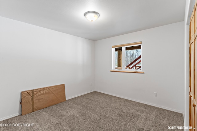 unfurnished bedroom with baseboards and carpet