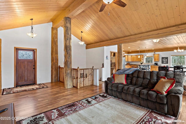 living area featuring wooden ceiling, light wood-style flooring, ceiling fan with notable chandelier, and lofted ceiling with beams