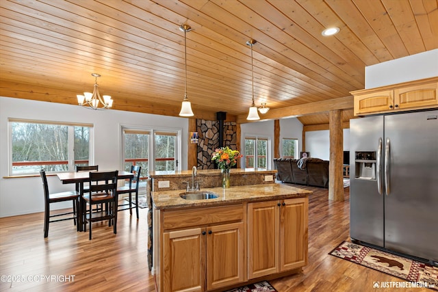 kitchen featuring light wood-style floors, stainless steel fridge, a wealth of natural light, and a sink