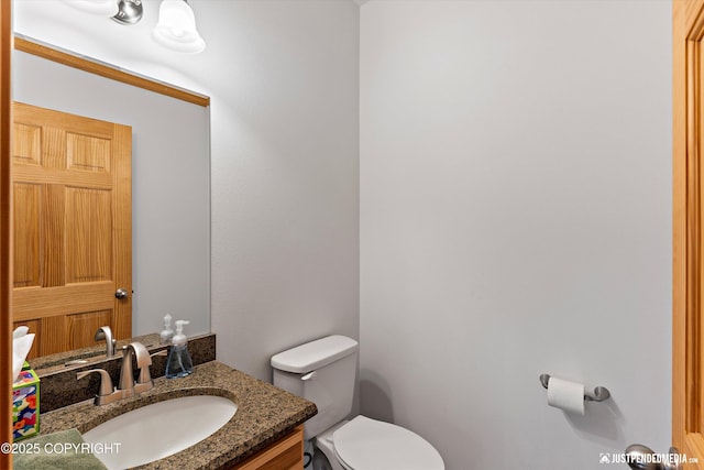 bathroom featuring toilet and vanity