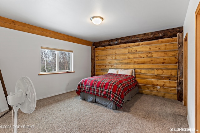 bedroom with carpet flooring and log walls