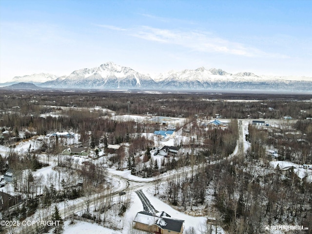 snowy aerial view with a mountain view