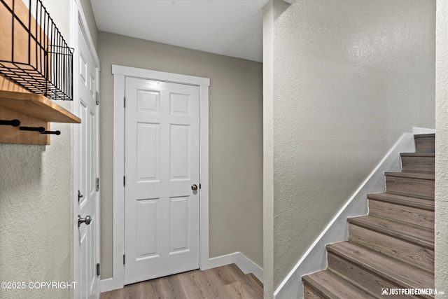 stairs with hardwood / wood-style flooring