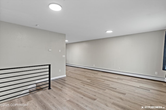 interior space with baseboard heating and light hardwood / wood-style flooring