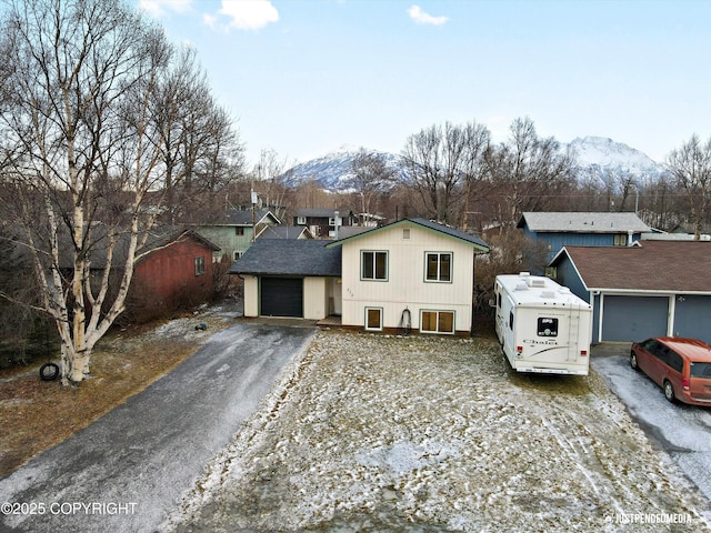 view of front of property with a mountain view and a garage