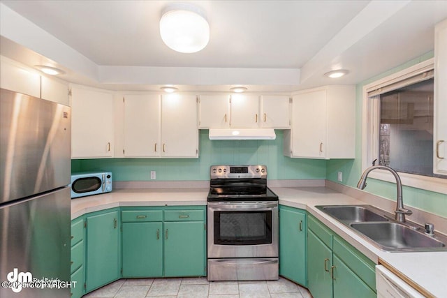 kitchen with white cabinets, stainless steel appliances, light tile patterned floors, green cabinets, and sink