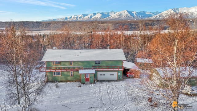 snowy aerial view featuring a mountain view