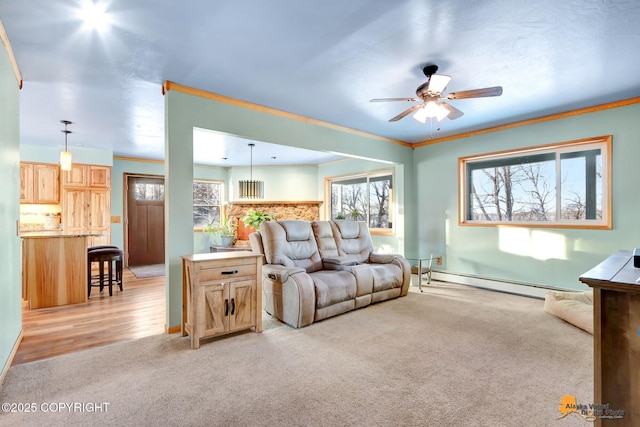 carpeted living room featuring ceiling fan and a baseboard radiator