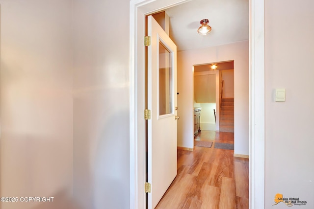 corridor with light wood-type flooring