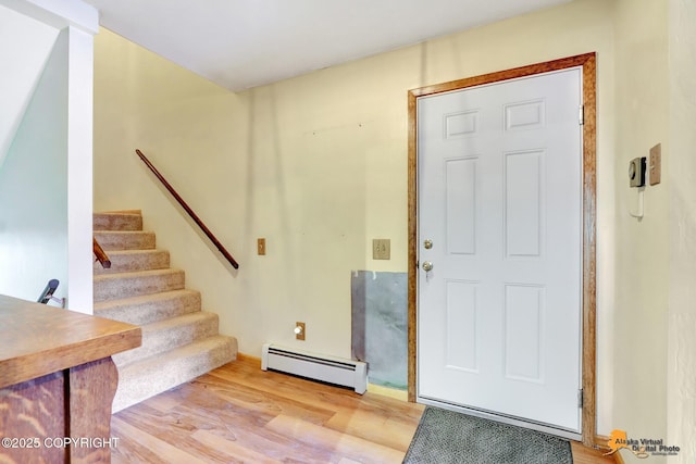 entrance foyer featuring a baseboard heating unit and light wood-type flooring