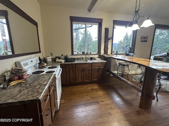 kitchen with white range with electric stovetop, decorative light fixtures, beamed ceiling, sink, and dark wood-type flooring