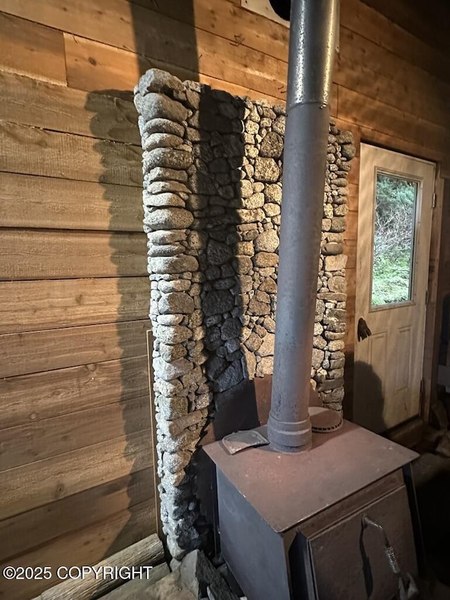 details featuring a wood stove and wood walls