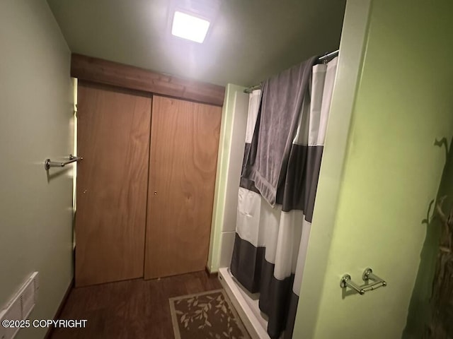 bathroom featuring hardwood / wood-style floors and curtained shower