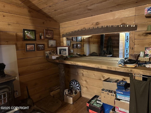 bar with wooden ceiling, vaulted ceiling, and wood walls