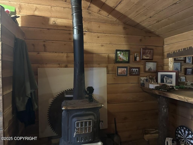 details featuring wood ceiling, wood walls, and a wood stove