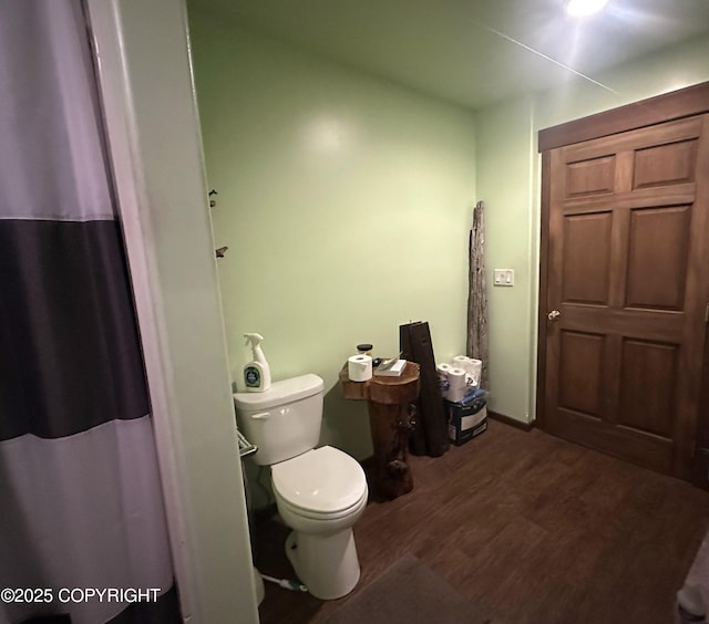 bathroom featuring hardwood / wood-style floors and toilet