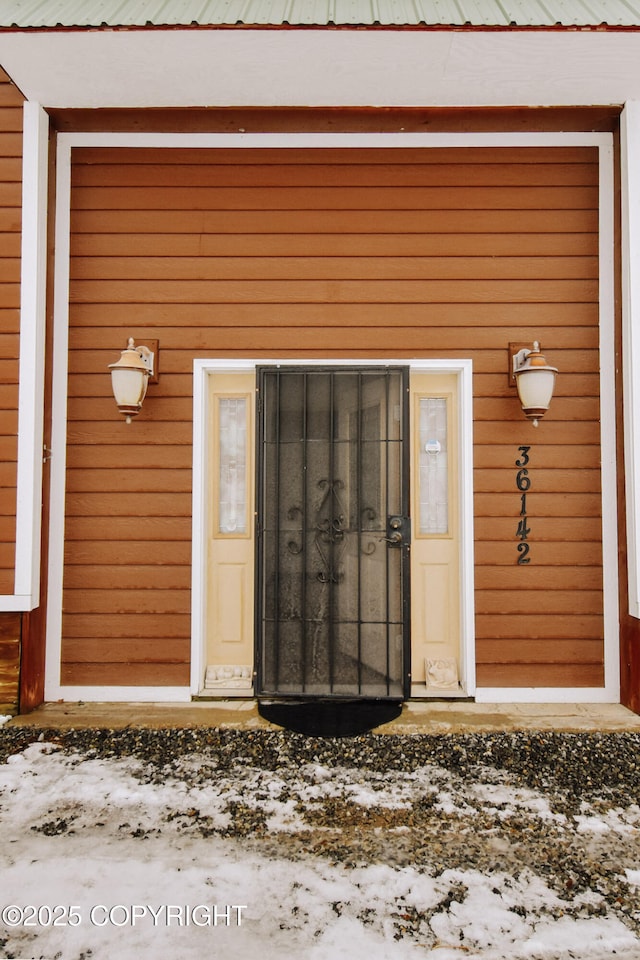 view of snow covered property entrance