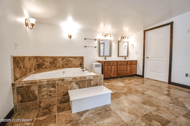 bathroom with a relaxing tiled tub, radiator, and vanity