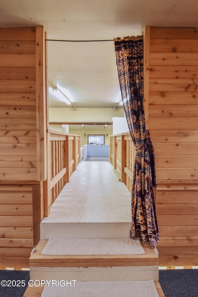 staircase with wood walls