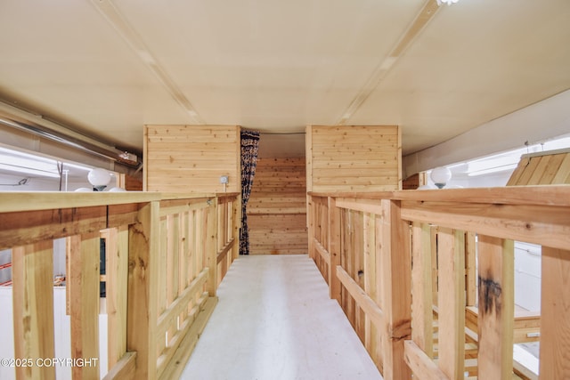 corridor featuring wooden walls