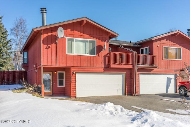 view of front of house featuring a balcony and a garage