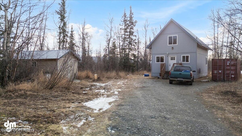 view of side of home with driveway