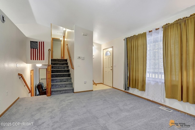 interior space with carpet floors and lofted ceiling