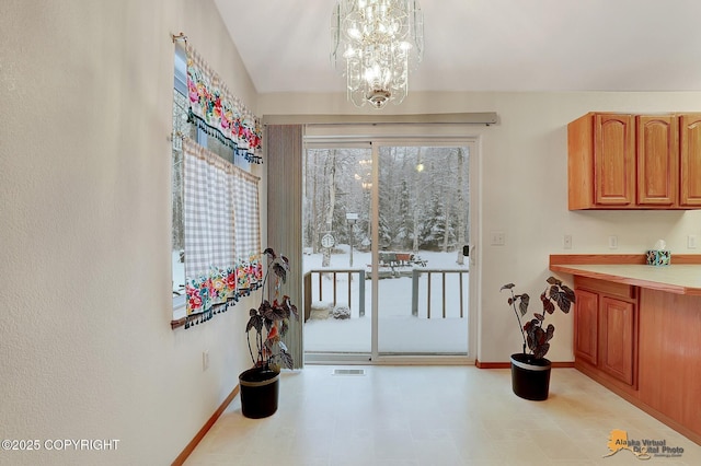 doorway with a notable chandelier