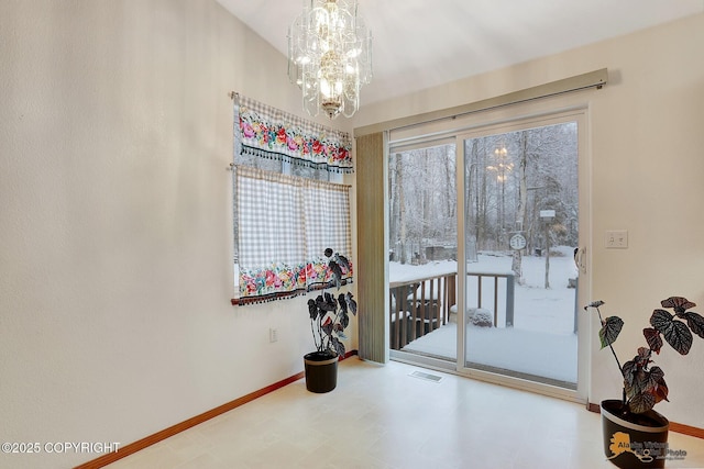 entryway with a notable chandelier