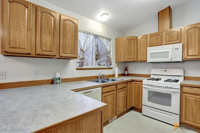 kitchen with white appliances, vaulted ceiling, and sink