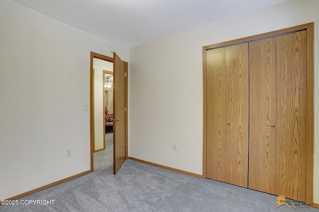 unfurnished bedroom with a closet and light carpet