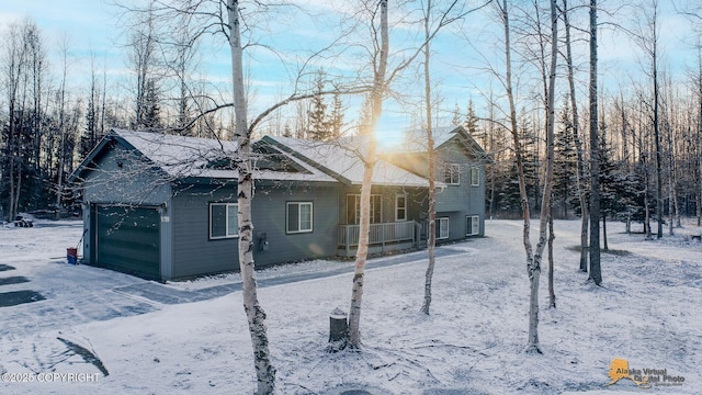 view of snowy exterior with a garage