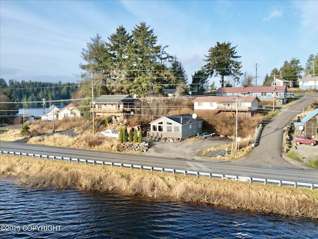 birds eye view of property with a water view