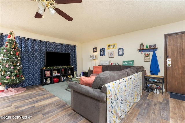 living room with wood-type flooring, a textured ceiling, and ceiling fan