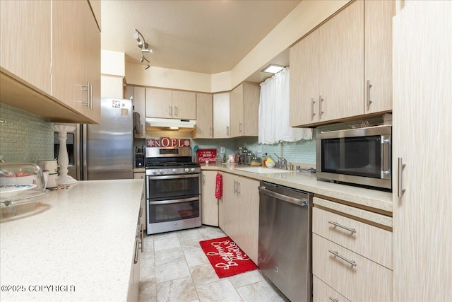 kitchen featuring backsplash, sink, stainless steel appliances, and light brown cabinetry