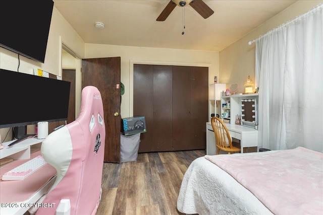 bedroom featuring dark hardwood / wood-style flooring, a closet, and ceiling fan