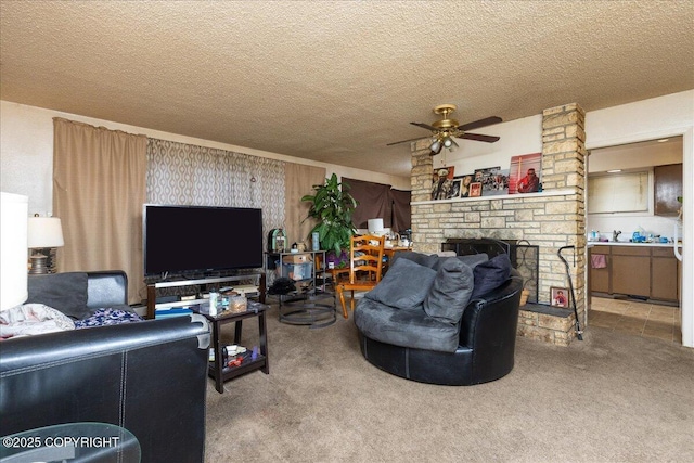 living room with carpet, ceiling fan, a fireplace, and a textured ceiling