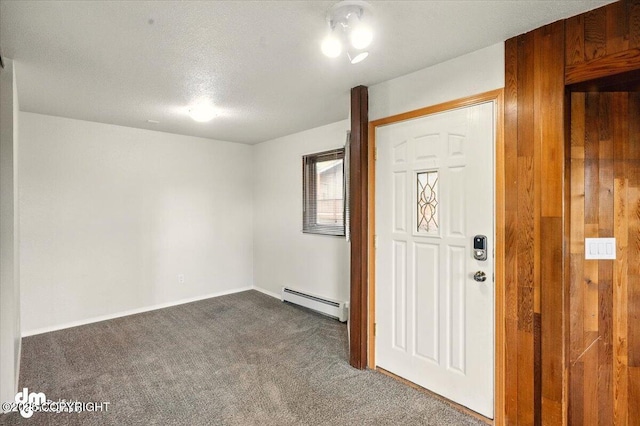 foyer entrance featuring baseboard heating, dark carpet, baseboards, and a textured ceiling