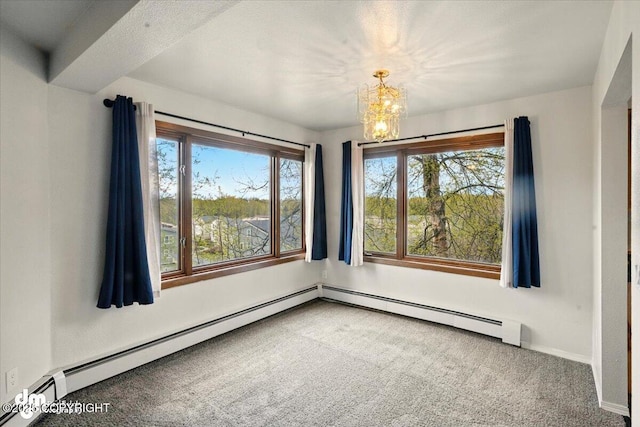 spare room with carpet, a chandelier, baseboard heating, and baseboards