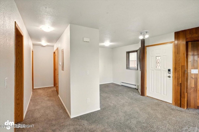 carpeted entryway featuring baseboard heating, a textured ceiling, and baseboards
