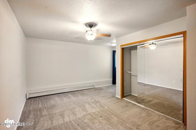 unfurnished bedroom with a baseboard radiator, carpet, a closet, a textured ceiling, and a ceiling fan