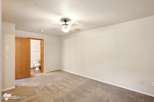 unfurnished room featuring carpet flooring, a ceiling fan, and baseboards
