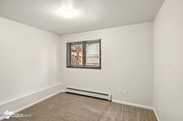carpeted spare room featuring baseboard heating, baseboards, and a textured ceiling