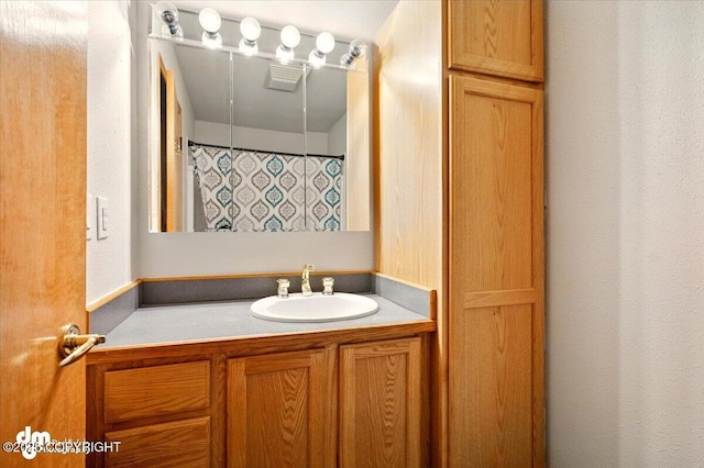 full bathroom with vanity and a shower with shower curtain