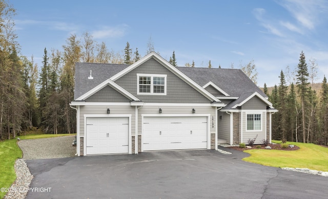 craftsman-style house with a front yard and a garage