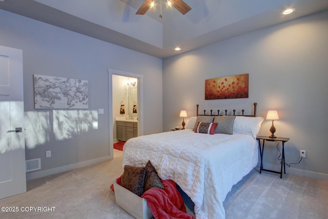 carpeted bedroom with connected bathroom, ceiling fan, and a towering ceiling