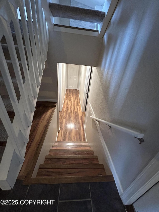 stairs featuring wood finished floors