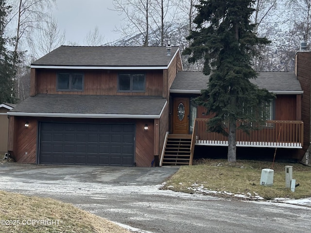 view of front facade featuring a garage, a chimney, aphalt driveway, and roof with shingles